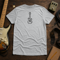 Sport Gray Pixel Guitar tee by Steady Strum, laid flat on a wood desk with guitar gear