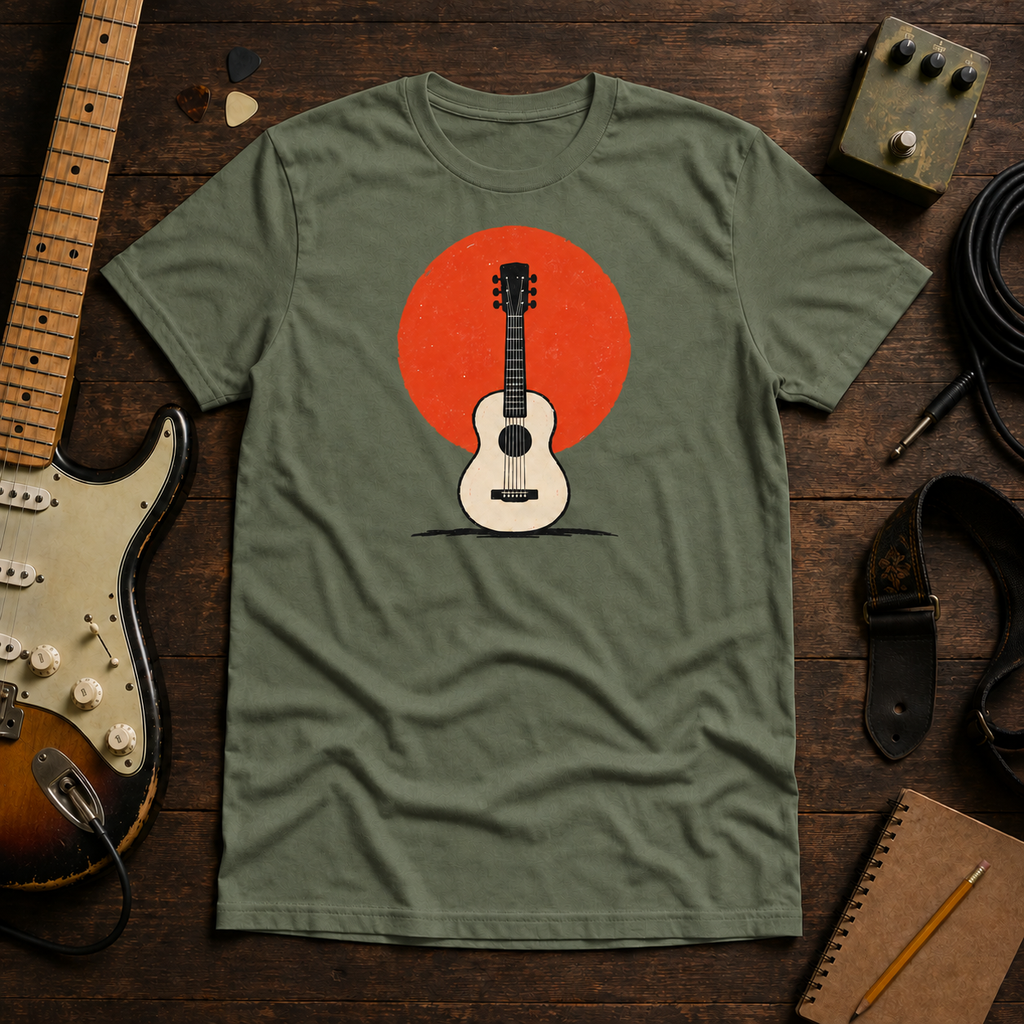 Green Sun. Set. tee by Steady Strum, laid flat on a wood desk with guitar gear