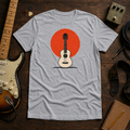 Grey Sun. Set. tee by Steady Strum, laid flat on a wood desk with guitar gear